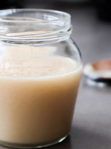Homemade condensed milk in a glass.