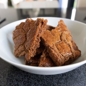Speculaas cookies in a white bowl.