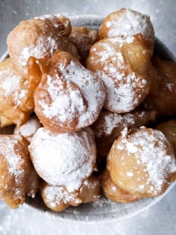 Oliebollen with powdered sugar.