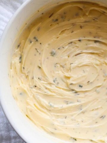 Garlic butter in a white bowl.