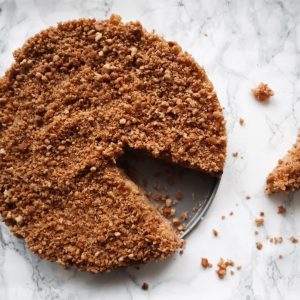Overheadshot of an graham cracker crust apple pie with a crumble topping.
