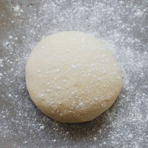 A close up of a ball of homemade pizza dough.