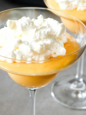 Advocaat with chantilly cream or egg liquer in a glass close up.