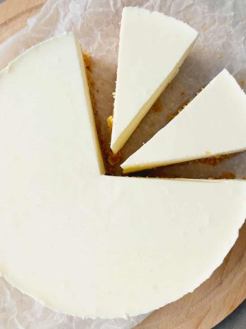 Overhead shot of no bake lemon pie on baking paper and a wooden board.