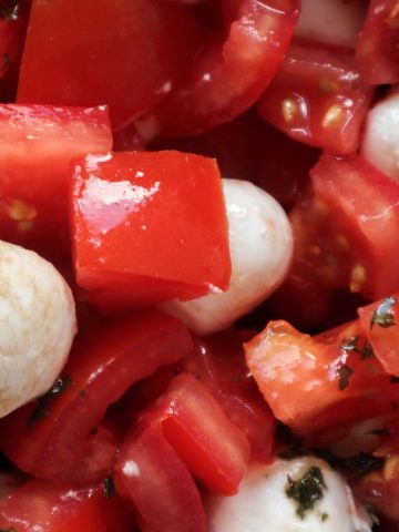 Overhead shot of a salade caprese with mozzarella and balsamic glaze.
