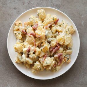 A close up of a salad with potatoes as the featured image.