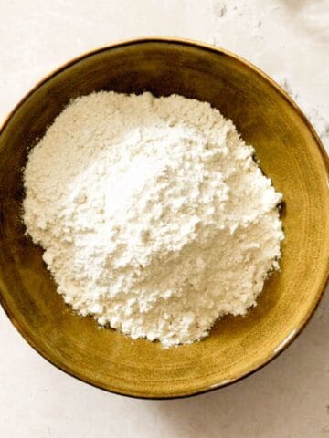 Homemade self-rising flour in a yellow bowl.