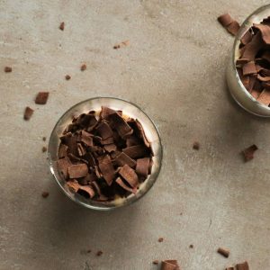 An overhead shot of oats with coconut milk and chocolate.