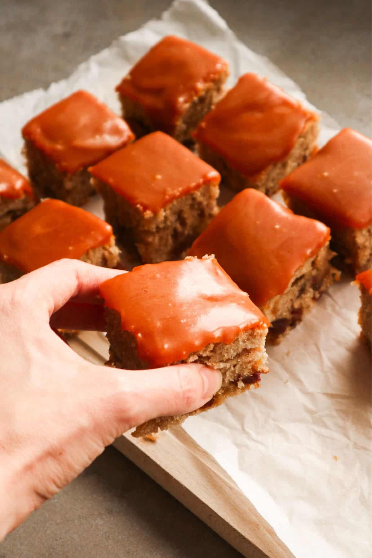 Eight pieces of date cake on a piece of baking papier.