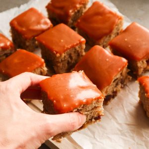 A close up of walnut date cake with caramel.