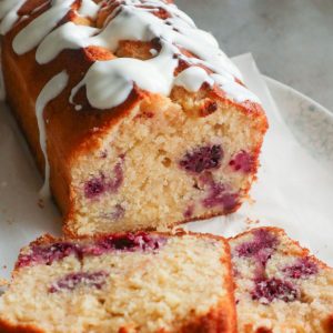 Two slices of lemon cake with blackberries.