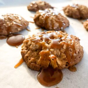 Apple caramel oatmeal cookies on a baking sheet.