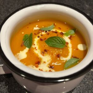 Soup with cream topping in a bowl.