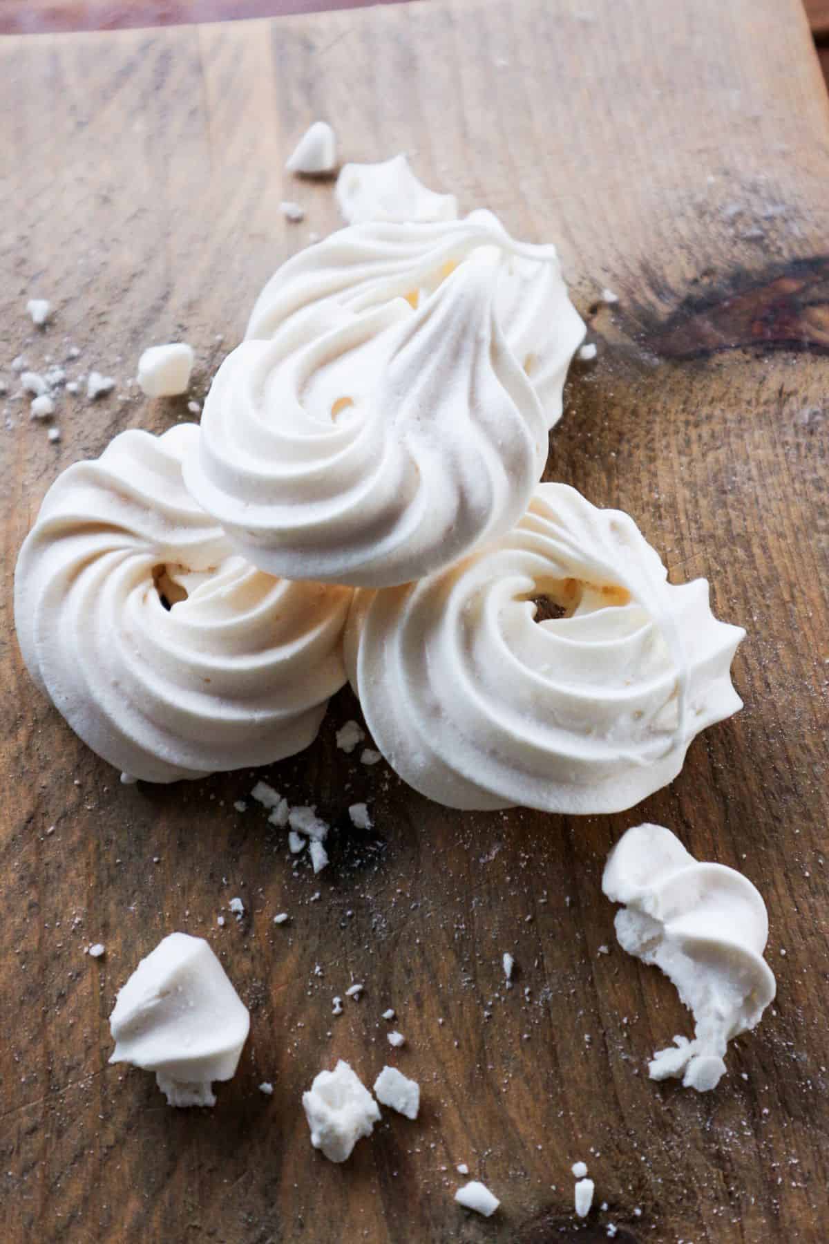 Meringue kisses on a cutting board.