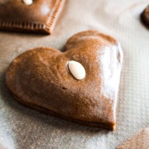 Almond speculaas cookie in the shape of a heart.