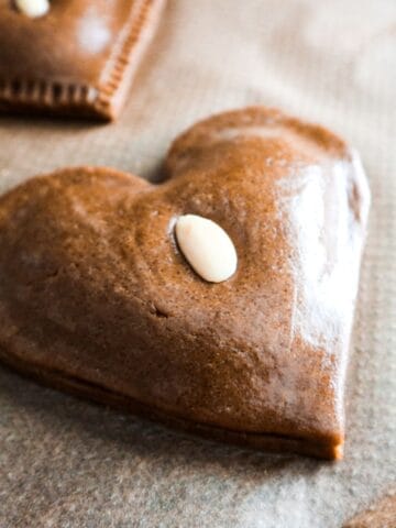 Almond speculaas cookie in the shape of a heart.